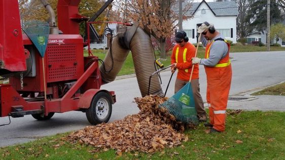 Town of Ingersoll Public Works Staff using leaf-pickup utility truck on residents boulevard